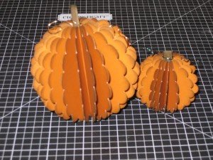 a large and small scalloped pumpkin
